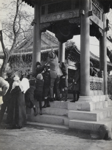 Children helping to ring the bell at the British Legation, Beijing - for the Armistice 1918