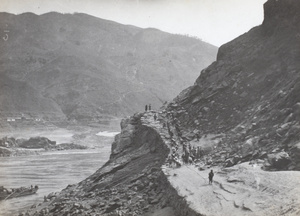 Trackers hauling a boat around a bend in the Upper Yangtze River, at a roller point
