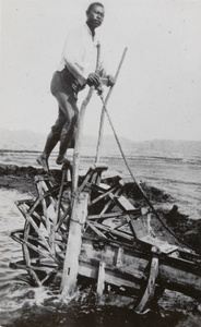 A man powering a waterwheel