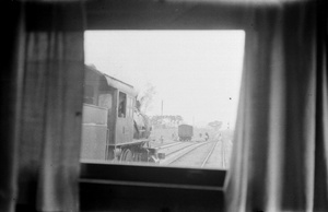 A locomotive viewed from another train