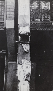 The exposed head of an executed man tied up by a shop