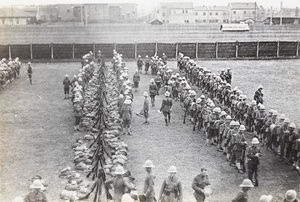 British soldiers (Shanghai Defence Force) assembled with their kit on a football pitch, Shanghai