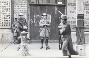 Scottish Company, Shanghai Volunteer Corps, on guard by a luggage shop, Shanghai, 1927