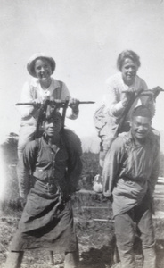 Ethel Vinden and another woman being carried by porters