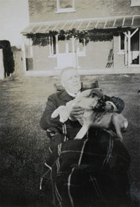 Hedgeland with a dog in a garden