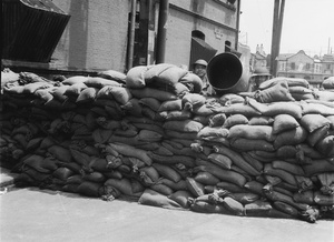 Two soldiers behind a barrier of sandbags, Shanghai, August 1937