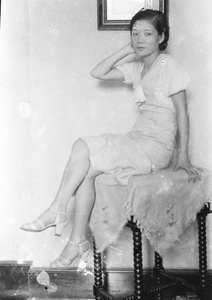 Unidentified woman posed on an occasional table, Shanghai