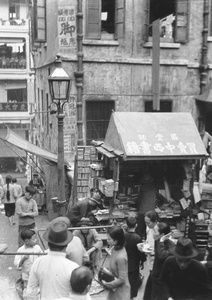 Book stall, pedlar, and shoppers, Hong Kong