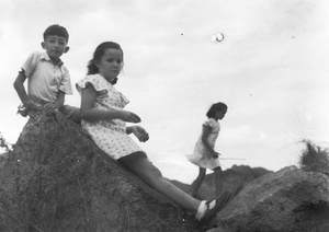 Jim Hutchinson, Kristine and Patricia Thoresen, playing on a stony outcrop, near the Army Sports Ground, Mongkok, Hong Kong