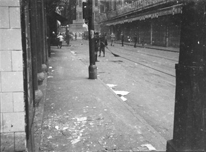 Sweeping up debris in a street near Sincere's in the aftermath of bombing, Shanghai, 23 August 1937