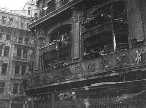Bomb damage to the upper story exteriors of Sincere Company and Wing On department stores, Shanghai, August 1937 