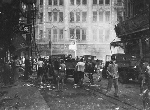 Clearing up debris after the bombing near Sincere Company and Wing On department stores, Shanghai, 23 August 1937