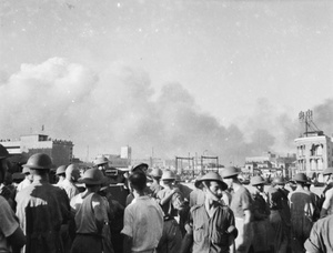 Soldiers on the roof of a building as clouds of smoke drift over Shanghai, August 1937