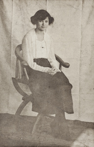 Molly Noble sitting in a wooden chair, Shanghai