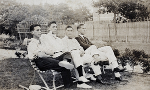 John Piry, Bill and Charles Hutchinson, and an unidentified man seating on a garden bench, 35 Tongshan Road, Hongkou, Shanghai