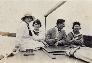Charles Hutchinson with three young woman on an excursion boat