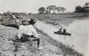 Man and woman in a punt watched by friends and farm workers, Shanghai