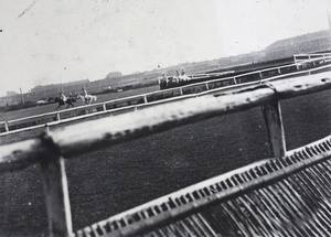 Horses racing around a steeplechase course, Shanghai Race Club