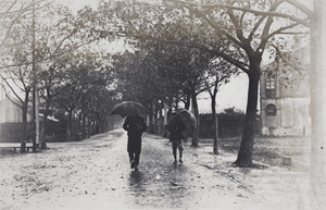 Two men walking with umbrellas in the rain, Tongshan Road, Hongkou, Shanghai