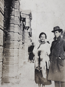 Tom Hutchinson with a young woman wearing a Chinese-style jacket and holding fox fur stole, Shanghai