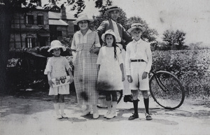 Bill Hutchinson on a bicycle, and Hannah with three unidentified children, Hongkou, Shanghai