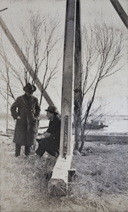 Tom Hutchinson and John Piry under the wooden girders of a tide house, Wusong, February 1920