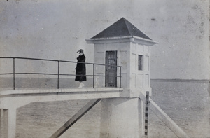 Young woman on the footbridge to a tide house, Wusong, February 1920