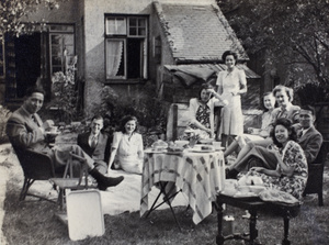 Gladys Hutchinson with a group of unidentified people at a garden tea party