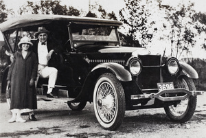 Margie and Charles Hutchinson posing beside their automobile, Wusong, September 1923