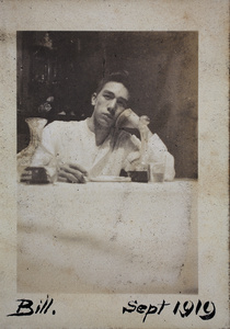 Bill Hutchinson sitting at a table in the dining room, 35 Tongshan Road, Hongkou, Shanghai 