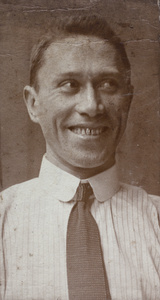 Unidentified man smiling, with a gold front tooth