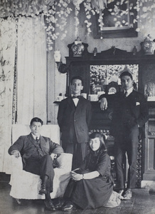William, Maggie, and Bill Hutchinson, with John Piry, in the festively decorated living room, 35 Tongshan Road, Hongkou, Shanghai