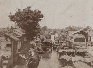Sampans, river boats and waterway activity photographed from a bridge, Kunshan