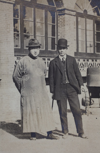 William Hutchinson wearing a suit and bowler hat with an unidentified man wearing a silk robe and fedora hat, 35 Tongshan Road, Hongkou, Shanghai