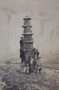 John Piry, John Henderson, Maggie and Harry Hutchinson with other friends posing around the base of a stone pagoda, Kunshan
