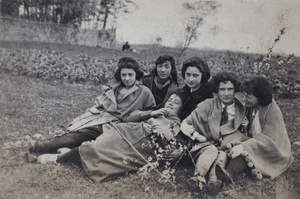 Maggie Hutchinson and friends, with branches of winter flowering almond, sitting in a field, Kunshan 