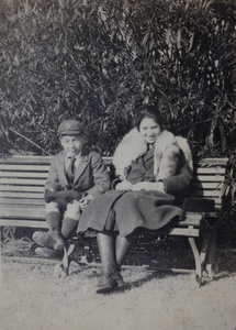 Fred and Sarah Hutchinson sitting on a park bench, Shanghai