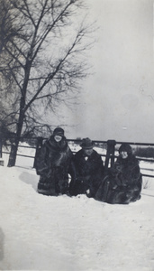 Friends of Margie Hutchinson, photographed sitting on the snow, Rochester, New York, 1923