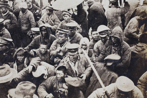 Civilians and soldiers behind barbed wire at the Avenue Haig internment camp, Shanghai