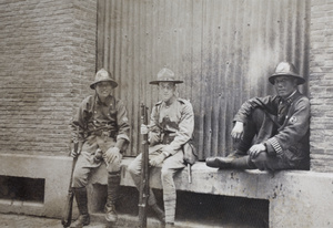 Two French Army Tonkinese (Vietnamese) guards with Mr Keane (American Company, Shanghai Volunteer Corps), at a sub-station, Peking Road, Shanghai, 1925