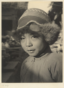 Boy wearing fur-lined Mongolian hat