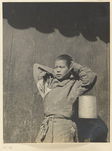 Boy holding metal bucket