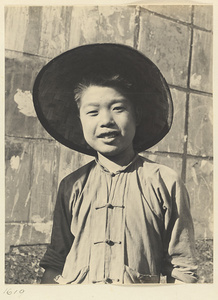 Boy wearing a sun hat made of woven plant fibers