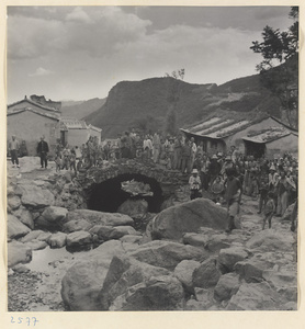 Villagers gathered on the bridge in Tio-liu-po Village [sic]