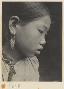 Woman wearing earrings with floral motif in the Lost Tribe country