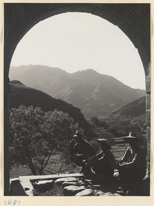 Guides resting in the archway of the Da long men in the Lost Tribe country