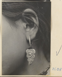 Woman wearing an earring with a floral motif in the Lost Tribe country