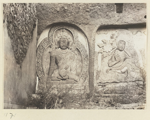 Building detail showing relief carvings of a Bodhisattva and a Lama