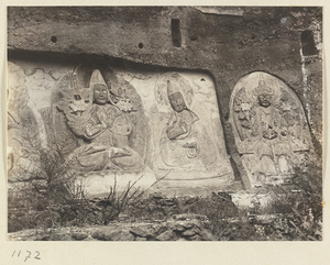Building detail showing relief carvings of Lamas and a Bodhisattva