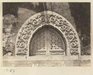 Facade detail of Da hong tai at Xu mi fu shou miao showing arched latticework window with marble relief work